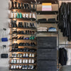 Walk-In closet made from strong dark iron pipes and wooden shelves with wall mounted hooks for bags