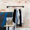 simple wall mounted clothes rail made from sturdy dark iron pipes industrial design