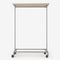 Clothes rack in silver pipes with wheels and wooden shelf in light pine