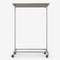 Clothes rack in silver pipes with wheels and wooden shelf in smoked oak
