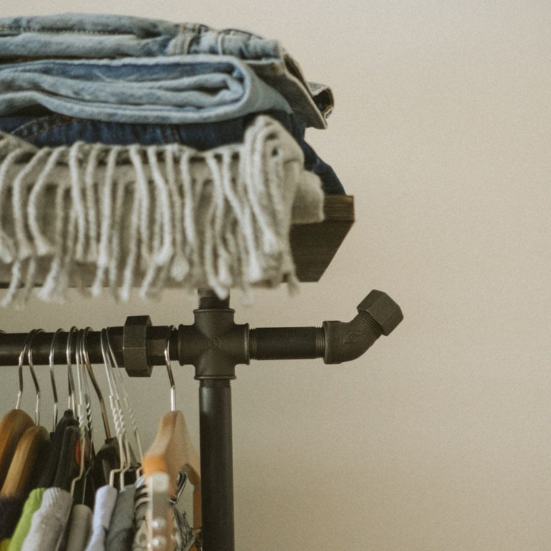 Clothing rack made from industrial dark water pipes with shelf and hook on the side