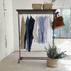 Free standing hanging clothes on feet with shoe rack made from iron pipes stable with hooks for bags and shelf