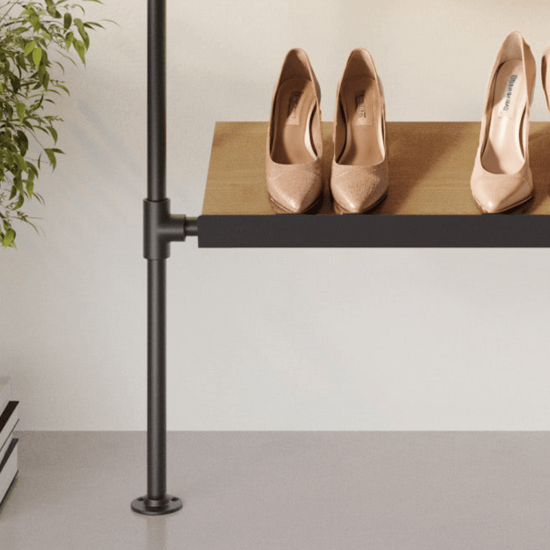 Schlichte Schuhablage mit zwei Paar beigen Damenschuhen auf Holzbrett, seitlich Pflanze und neutrale Wandfarbe