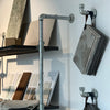 Silver hooks wall mounted for hanging bags and product samples in store modern design