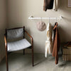 Wall mounted clothing rail made from square white iron pipes, minimalistic design modern interior