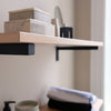 Wall mounted shelf attached with black L brackets stable support with oak shelf perfect for bathroom