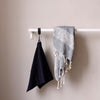 Wall mounted clothing rail made from white iron pipes perfect for towels in the kitchen