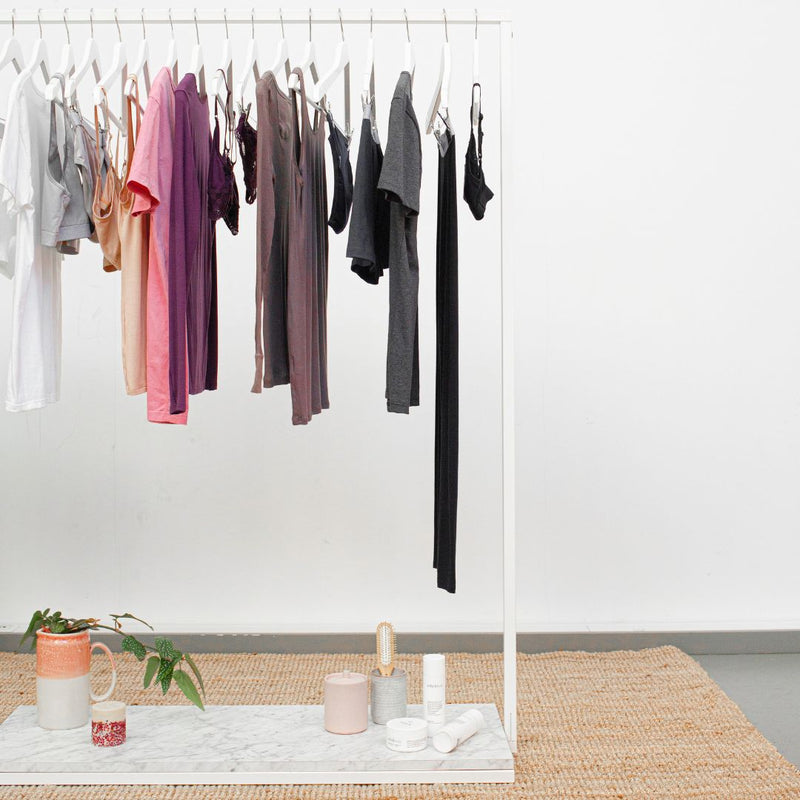 free standing display rack for clothes store  simple design in white with marble look