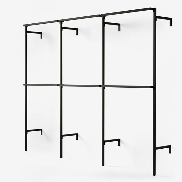 The wardrobe system consists of three modules with double hanger bars for shorter clothes. The frame is black powder-coated pipes.