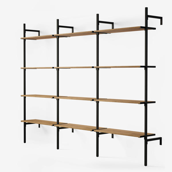 Shelving system in black powder coating with 3 sections with 4 oak veneer shelves in classic oak in each section.