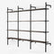 Shelving system in black powder coating with 3 sections with 4 oak veneer shelves in smoked oak in each section.