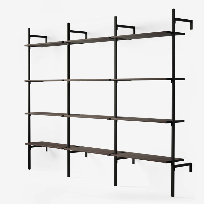 Shelving system in black powder coating with 3 sections with 4 oak veneer shelves in smoked oak in each section.