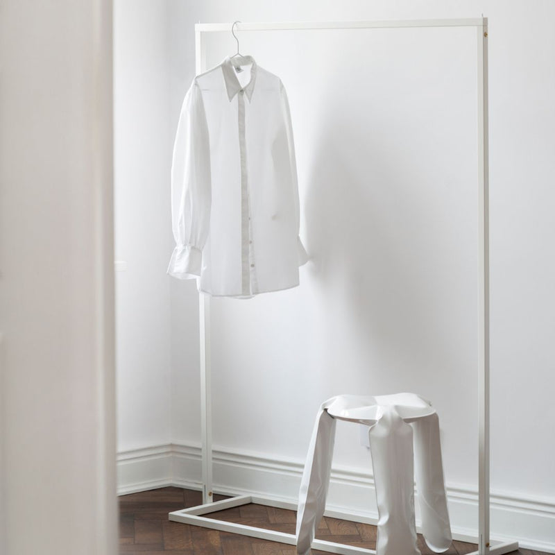 Free standing clothes rack made from square white iron pipes stable and stylish