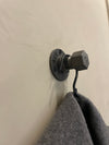Wall mounted hook made from industrial water pipes to hang scarfs and towels