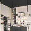 Modern interior in kitchen with ceiling mounted iron pipes to attached pots and pans