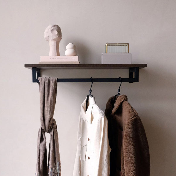 Wall mounted clothing rail made from black iron pipes with smoked oak shelf on the top