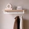 wall mounted shelf in oak with modern rail in white square iron pipes for jackets