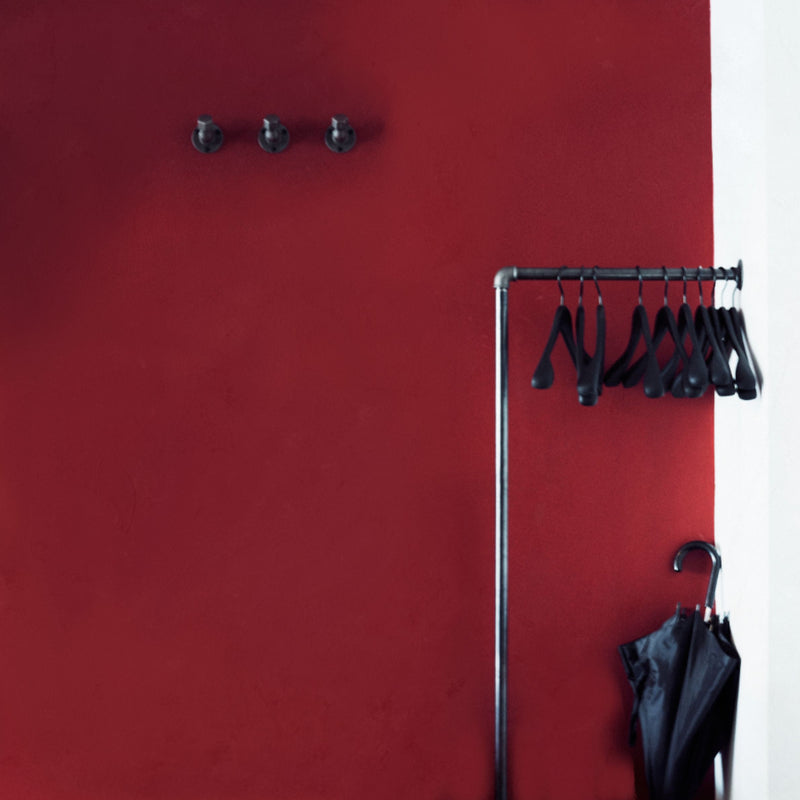 Wall mounted hooks for coats and jackets in industrial design for the entrance area