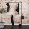 industrial clothes rack made from dark water pipes sturdy free standing solution