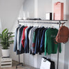 Freestanding clothes rack for sweaters with shoe rack at the bottom and shelf on top for decoration and hook for bags