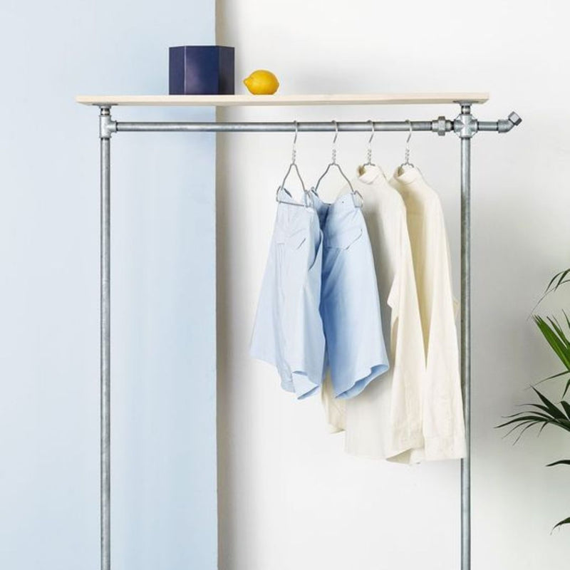 Free standing clothes rack made from silver water pipes with light pine shelf on top and hook for bags