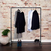 Free standing rack in industrial design made from dark water pipes for shoes and jackets