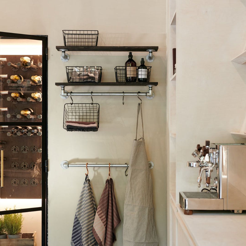 Wall set up in kitchen made from silver water pipes to hang towels with hooks with wooden shelves