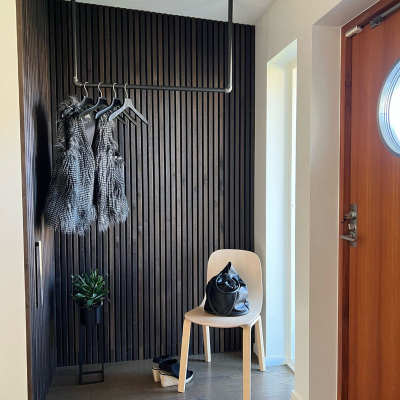 Scandinavian interior design in the entrance with dark clothes rail made from water pipes 