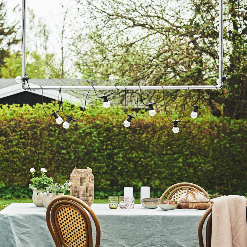 Simple U shaped iron rail galvanized attached to beam on terrace to hang light blubs 