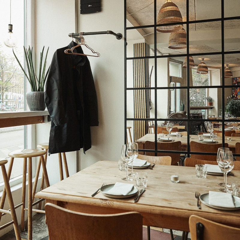 simplistic wall mounted clothes rail for guests jackets in restaurant industrial design