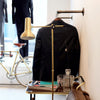 Wall mounted display rack for clothing store made from strong dark water pipes