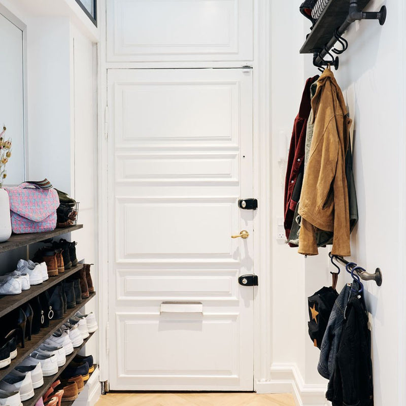 narrow entrance with practical storage solutions floating shelves and wall mounted clothes rails for jackets