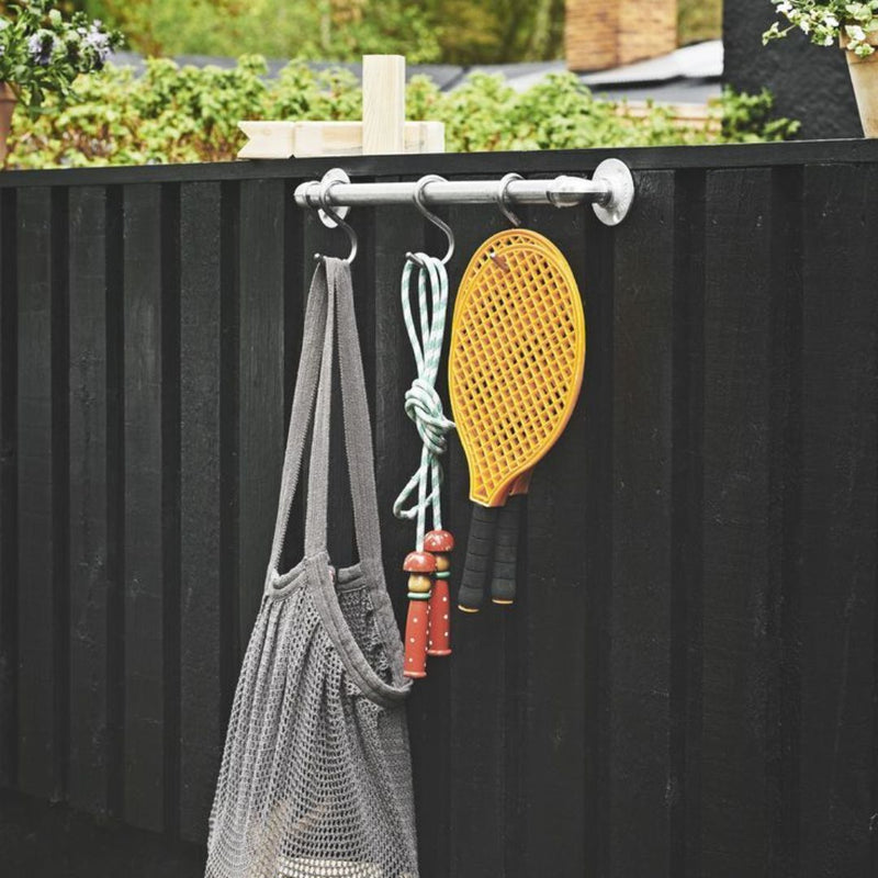 Wall mounted rust free short metal rail used outdoors to hang games for children