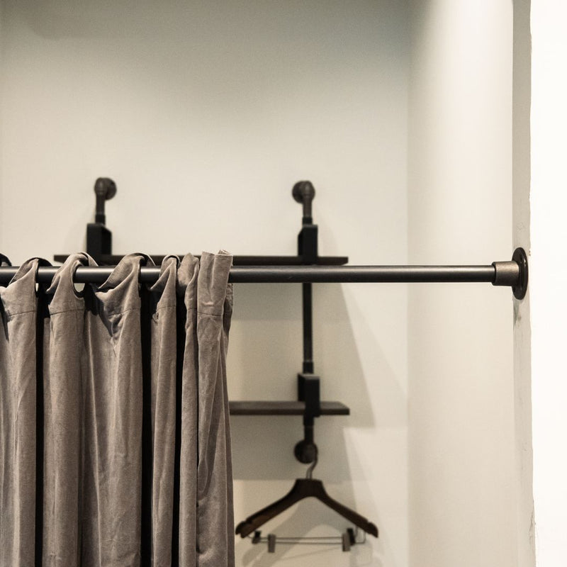 simple industrial iron rod for curtain in changing room mounted between two walls