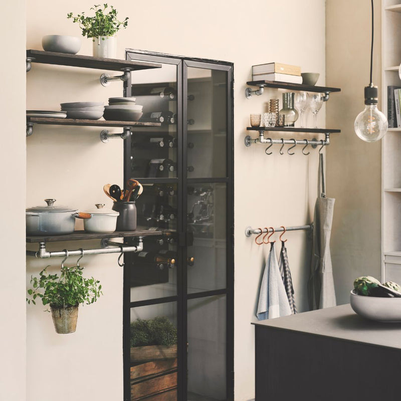 modern kitchen set up with industrial water pipe rails for towels and shelves on top for decoration