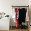 Free standing clothes rack made from dark iron pipes and massiv oak supports nordic design