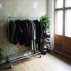 Free standing clothes rack on wheels made from iron pipes able to carry multiple winter jackets