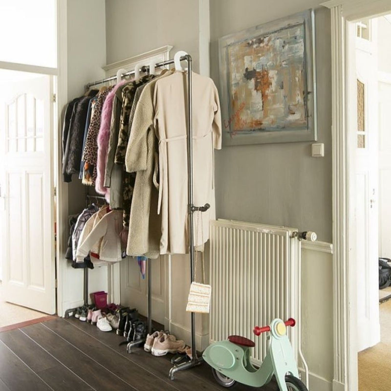 Free standing rack made from dark water pipes for jackets in the entrance with a lot of space